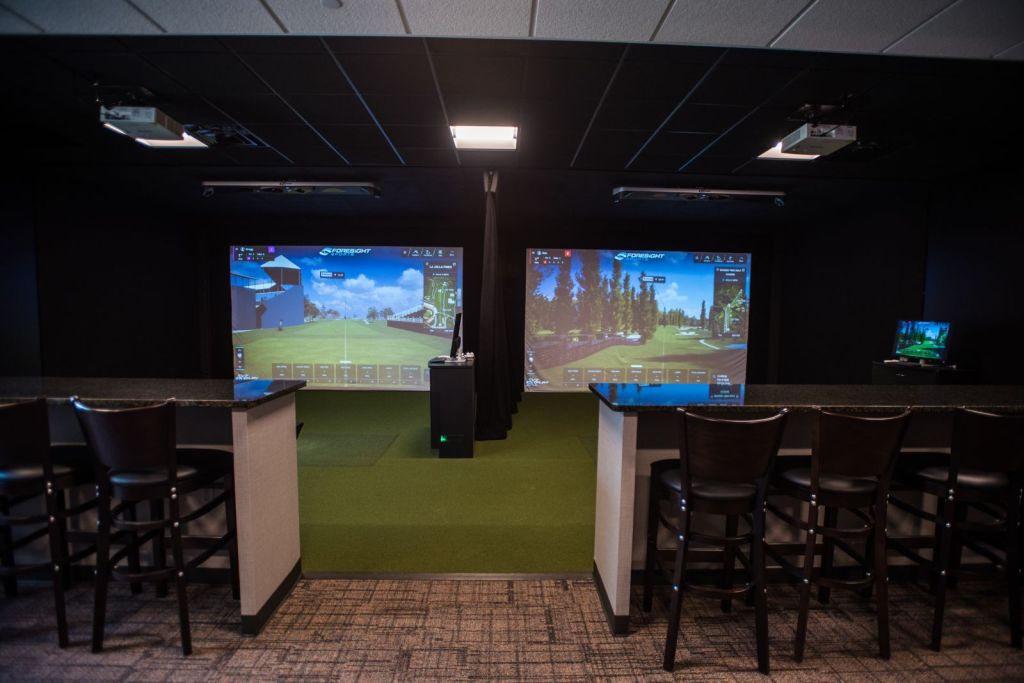 Photo of two high end simulators with high top tables